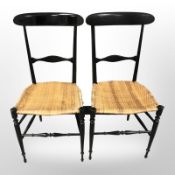 A pair of 20th century ebonised can seated chairs