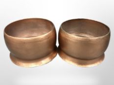 A large pair of hammered metal copper-finish garden planters,