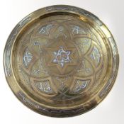 A Cairo ware brass charger with copper and silvered metal inlay, diameter 34cm.