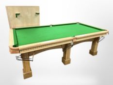 A high-quality three-section slate bed and polished beech-framed snooker table,