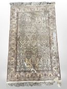 An Indian silk-piled rug, 130cm x 76cm (as found).