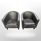 A pair of stitched black leather armchairs,