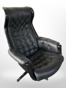 A 1970's black plastic aluminum and leather swivel armchair designed by Alf Svensson and Yngvar