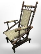 An early-20th century oak bobbin-turned rocking chair.