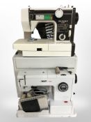 Three vintage electric and hand sewing machines by Major, Pfaff, and Vera.