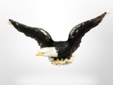 A large painted composition sculpture of a bald eagle,