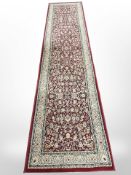 A machine-made runner of Persian design,