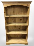 A contemporary pine open bookcase,