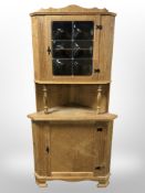 A Danish blond oak corner cabinet with leaded glass cabinet door,