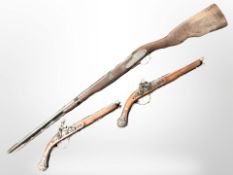 A decorative reproduction musket and pair of flintlock pistols.