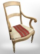 A 19th-century continental scroll arm armchair.