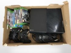 An Xbox One with lead, two controllers, quantity of games.
