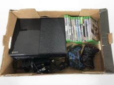 An Xbox One with lead, two controllers, quantity of games.