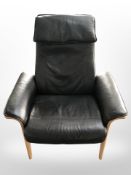 A Scandinavian beech framed black leather armchair,