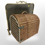 A glazed brass fire screen and a wicker pet carrier
