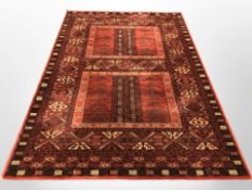 A machine made carpet of Afghan design,