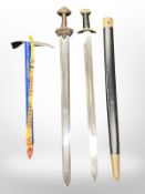 Two reproduction viking swords, one in scabbard, together with an ice pick.