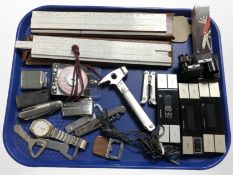 Two draughtsman's rules, a Swiss Army-style pocket knife, lighters, bottle openers, etc.