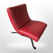 A contemporary Danish chrome and red stitched leather easy chair,