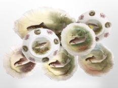 A group of French Limoges dishes and plates decorated with fish, largest 40cm wide.