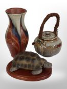A studio pottery vase, height 20cm, similar teapot, and an Aynsley tortoise on stand.