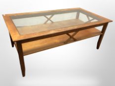 A 20th-century Danish teak rectangular glass-topped two-tier coffee table designed by Aksel