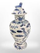 A 20th-century Chinese blue and white porcelain baluster lidded vase depicting a four-clawed dragon