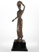A contemporary patinated metal sculpture of an African woman, height 35cm.