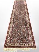 A machine-made runner of Persian design, 363cm x 92cm.