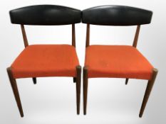 A set of three 1960s Danish teak-framed dining chairs with black vinyl back rests.