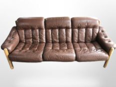 A 20th century Danish beech framed three seater settee in buttoned leather, length 210 cm,