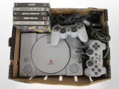 A Sony Playstation 1 with lead, two controllers, and five games.