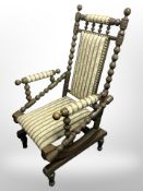 A continental beech bobbin-turned rocking chair in striped upholstery.