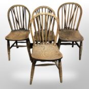 A pair of early-20th century elm spindle back dining chairs.