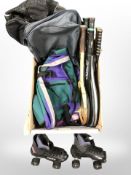 A group of tennis rackets, roller skates, hold-alls.