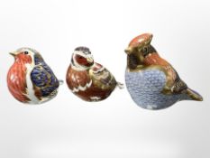 A Royal Crown Derby robin paperweight, plus two other bird paperweights, all with gold stoppers,