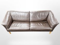 A Scandinavian brown stitched leather three seater settee,