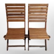 A pair of teak folding garden chairs.
