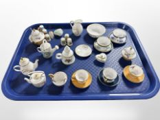 A collection of Caverswall and Spode miniature tea china, porcelain thimbles,