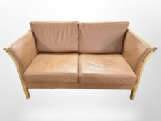 A contemporary Danish oak framed stitched tan leather two seater settee,