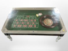 A contemporary roulette coffee table, with glass top,