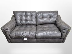 An Alexander & James charcoal grey stitched leather two seater settee,