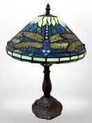 A Tiffany style patinated metal table lamp with dragonfly shade, height 45cm.
