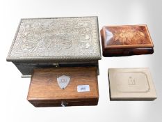 A Dunhill cigarette box, inlaid musical trinket box, oak box and an embossed metal box,