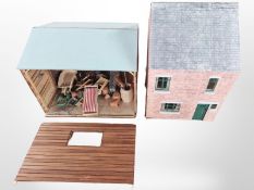 A doll's house, garden shed and two garden dioramas containing assorted decorations,