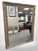 A reproduction bevelled mirror in an ornate frame,