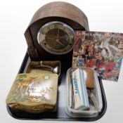 An Art Deco carved oak eight day mantel clock, together with a boxed razor and other accoutrements,