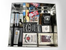 A tin containing assorted lighters including Colibri, Zippo, etc.