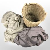 A wicker basket containing silk fabric.