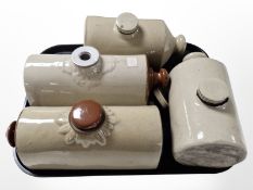 Four 19th-century stoneware hot water bottles.